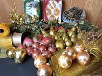 Overview of all decorations: loose ornaments, faux fruit, pinecones, greenery, ribbon rolls