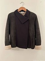 Front view of brown lambskin jacket on hanger