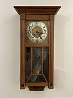 Front view of wall clock showing entire case and dial