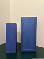 Front view of both blue resin rectangular vases standing side by side