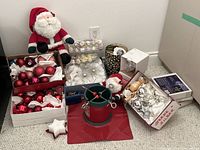 Overall lot showing tree stand, plush Santas, multiple boxes of ornaments