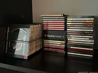 CDs in chrome rack and stacked jewel cases