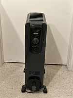 Front view of DeLonghi oil-filled radiator heater standing on carpet