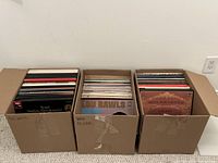 Three boxes filled with vinyl LPs