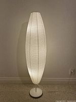 Full view of illuminated floor lamp against wall