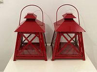 Front view of both red metal lanterns