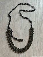 Full view of gunmetal rhinestone necklace laid flat