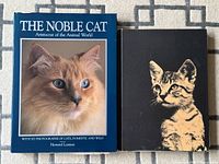 Front covers of both cat reference books