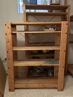 front view of pine shelf showing four tiers and paint stain