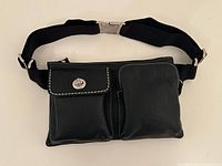 Front view showing two pockets, strap and clasp