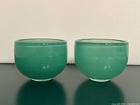 front view of both green art glass bowls