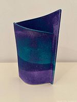 Front view showing asymmetrical curved purple and teal glaze