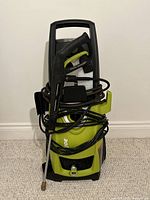 Front view of SunJoe SPX3000 pressure washer showing spray gun, hose and detergent tanks
