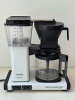 Front view of coffee maker showing reservoir, basket and base
