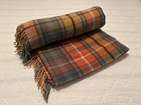 Blanket folded to show Buchanan plaid pattern and fringe
