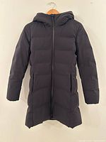 Full front view of black Uniqlo down jacket hanging