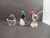 Front view of three glass animal figurines