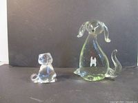 Dog and cat figurines side by side showing scale