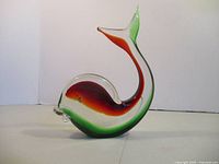 Right side view of curved red and green glass fish