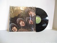 Front of Rubber Soul jacket in shrink with vinyl record partially visible