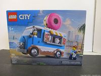 Front of sealed LEGO City 60452 box showing donut food truck and piece count