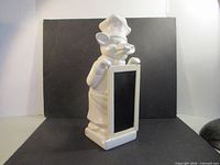 Front view of ceramic pig chef figurine with chalkboard