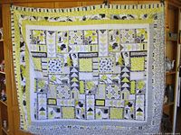 Full view of quilt hung, showing overall pattern and borders