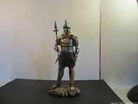 Full view of Roman soldier figurine on base holding spear