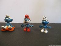Front view of all three Smurf figurines