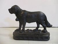 Left-side view of cast iron dog doorstop on base