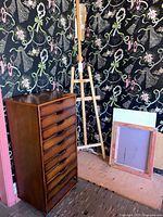 Cabinet, easel, art panels in context