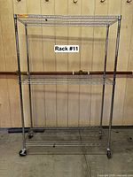Full view of chrome wire rack with three shelves on casters