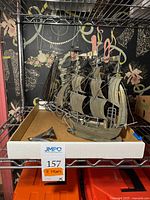 shelf view showing largest pressed metal ship and others in tray