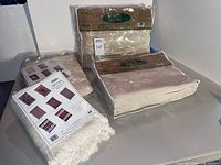 all four packaged cotton blankets on table