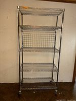 Full view of chrome five-shelf rack with casters