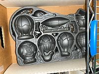 Cast iron novelty mold with multiple hot-air balloon and airship cavities