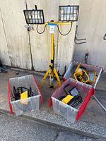 Overall lot: tripod stand with dual lights and three bins of portable lights