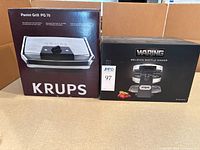 Krups Panini Grill PG70 and Waring Belgian Waffle Maker WMK220 retail boxes side by side