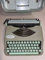 Top view of Hermes Rocket typewriter with mint green keys