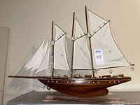 Starboard side view of full model ship on stand showing sails and rigging