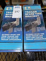 Front view of two boxed DL trailer spare tire brackets