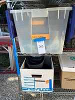 Shelf with clear tote and cardboard file box