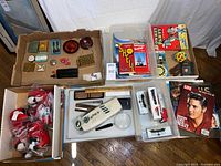 Overview of lot with train cars, maps, magazine, plush toys and accessories