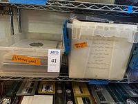 Two plastic totes on shelf holding numerous vinyl records