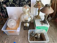 Lot overview showing pair brass lamps, hurricane lamp, two pendant globes and hardware