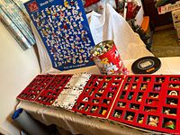 Overall lot with open display case, poster, tin and disc visible