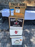 Four produce boxes labelled and stacked, containing Happy Meal toys