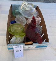 Box containing multiple colored glass covered animal bowls
