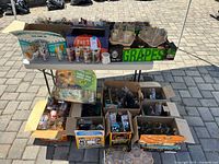 Overall view of table with multiple boxes of collectible glasses