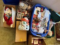 Overview of totes with boxed ornaments, glass dome, loose decor